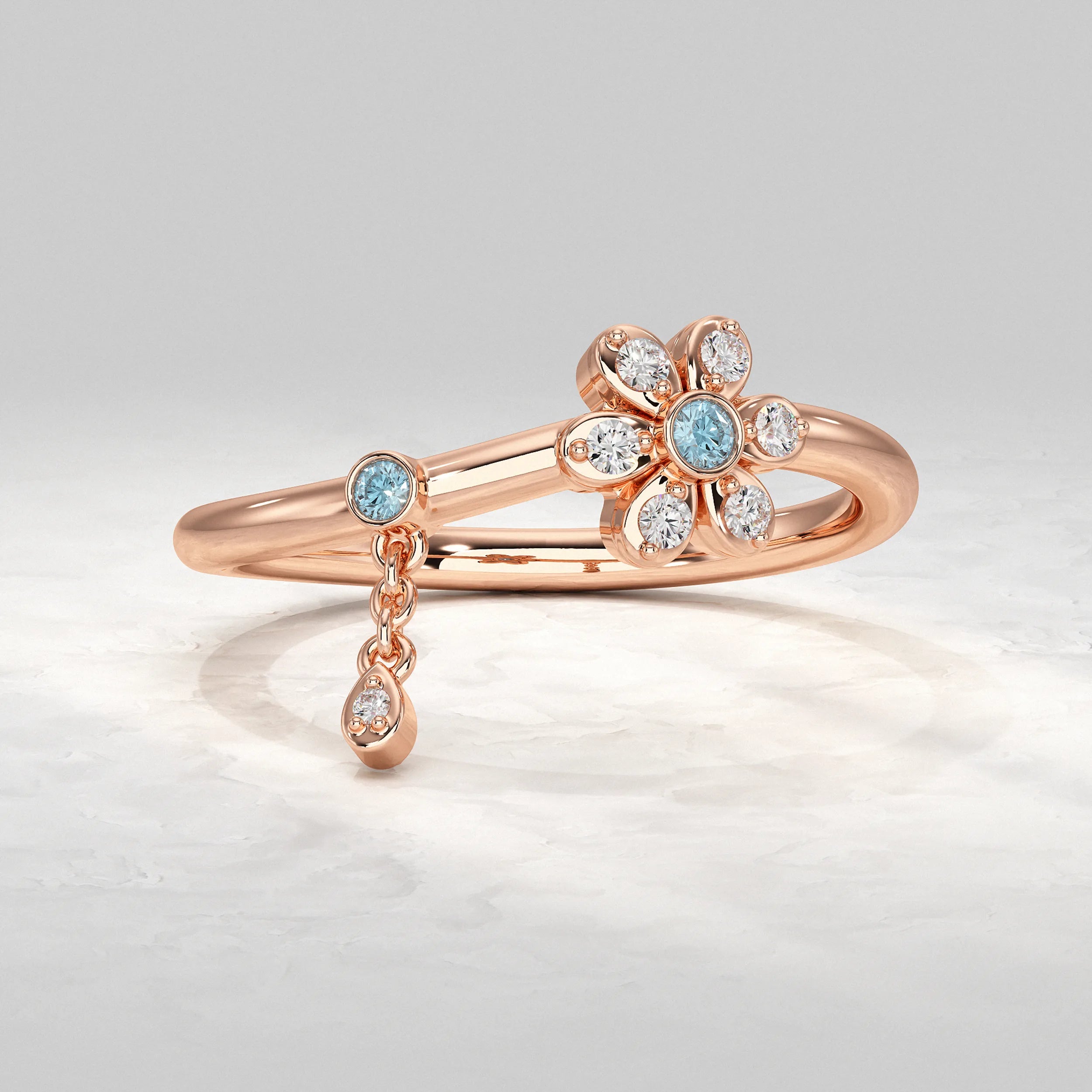 Elegant-Rose-Gold-Ring-With-Flower-Motif-And-Dangling-Diamond-Charm